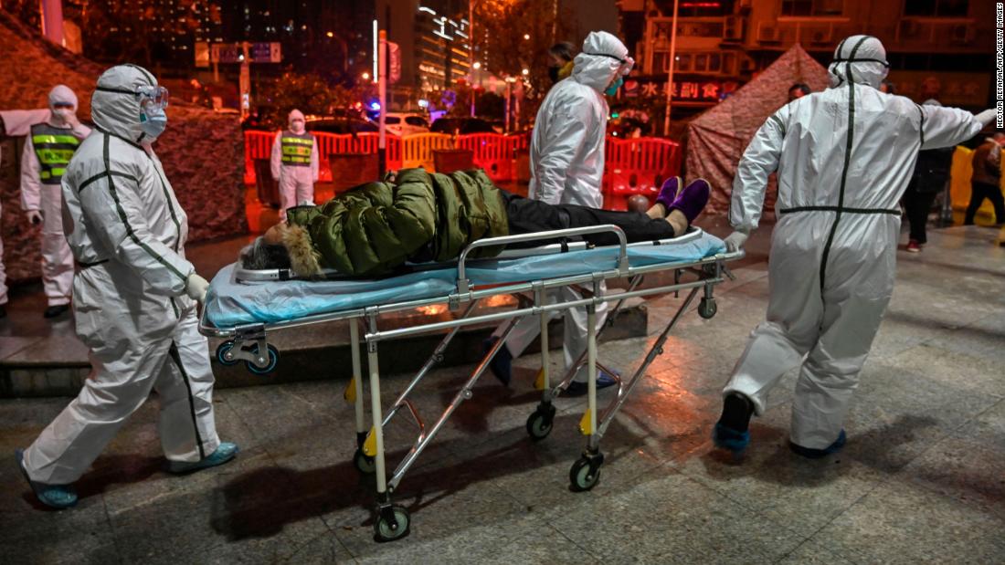 Medical staff members bring a patient to the Wuhan Red Cross hospital on January 25.