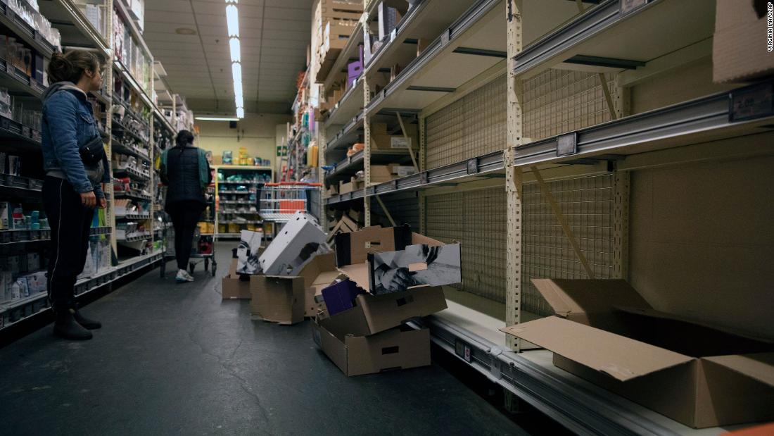 A woman looks at an empty bread aisle in Antwerp, Belgium, on March 13.